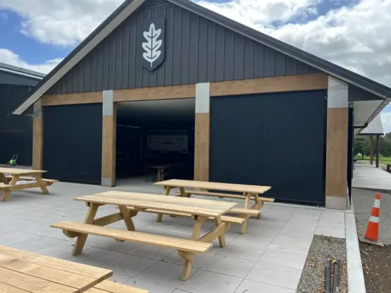 Masterton Golf Club - Large outdoor pavilion with outdoor living blinds installed across openings, featuring mesh outdoor blinds in Visiontex® Plus 94 with Cosy blinds, durable commercial outdoor blinds by Peace of Mind Shade and Screens, Rainbow Shade NZ