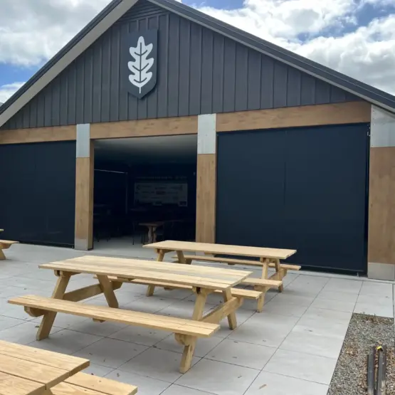 Masterton Golf Club - Large outdoor pavilion with outdoor living blinds installed across openings, featuring mesh outdoor blinds in Visiontex® Plus 94 with Cosy blinds, durable commercial outdoor blinds by Peace of Mind Shade and Screens, Rainbow Shade NZ