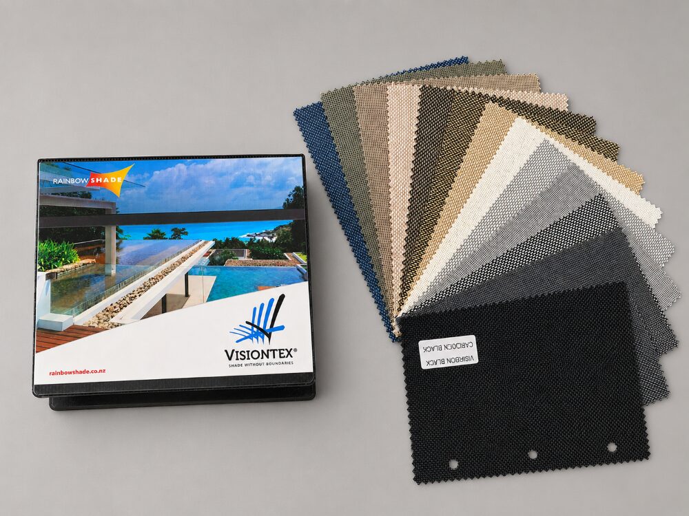 VisionTex Swatch VisionTex® mesh fabric swatch booklet by Rainbow Shade NZ with fanned colour samples, showcasing the full range of VisionTex® shade fabric colours for outdoor blinds and shade systems.