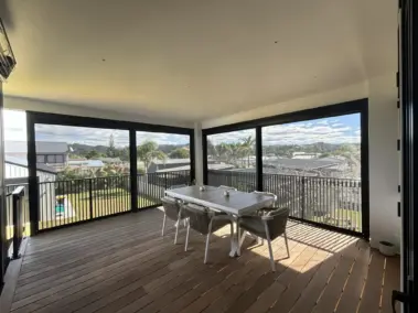 Covered outdoor dining area with outdoor living blinds using mesh outdoor blinds in Visiontex® Plus 94 Carbon Black with Ziptrak® blinds system, a stylish outdoor screen solution by Covered and Rainbow Shade NZ