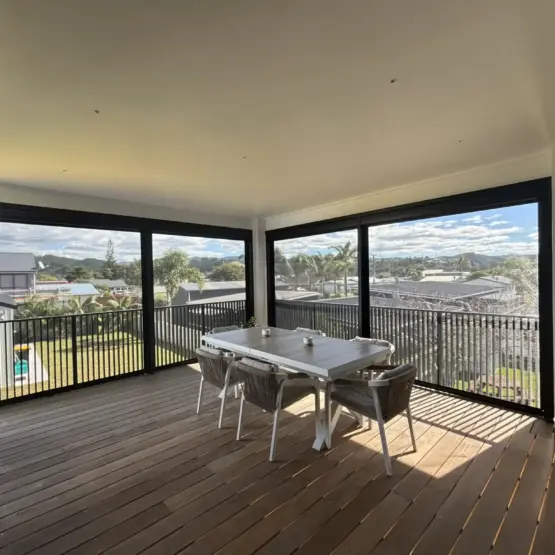 Covered outdoor dining area with outdoor living blinds using mesh outdoor blinds in Visiontex® Plus 94 Carbon Black with Ziptrak® blinds system, a stylish outdoor screen solution by Covered and Rainbow Shade NZ