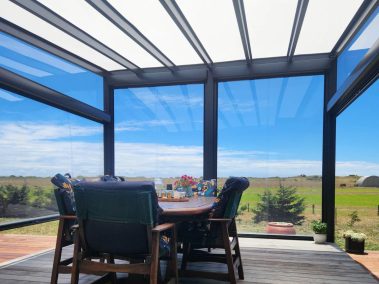 Ziptrak® clear PVC blinds create a great view from the outside deck and dinning area of the garden - by Archishade
